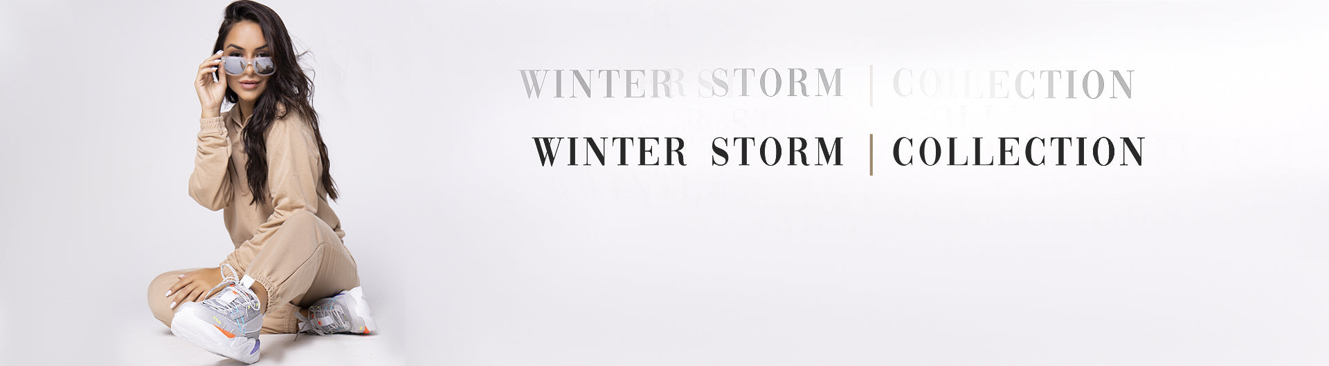 Banner da modelo com um conjunto de moletom, apresentando a coleção Winter Stom | Bravaa Store.